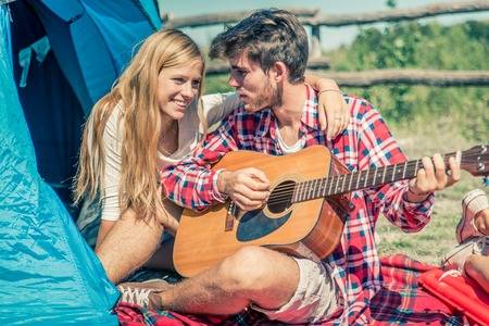 47114334-couple-in-a-camping-site-playing-guitar-and-singing-lovers-on-a-wekk-end-vacation-in-the-nature.jpg